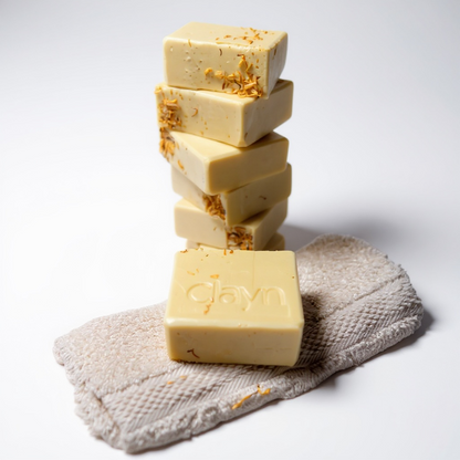 Stack of soap bars with 'glav' branding on a textured towel against a white background