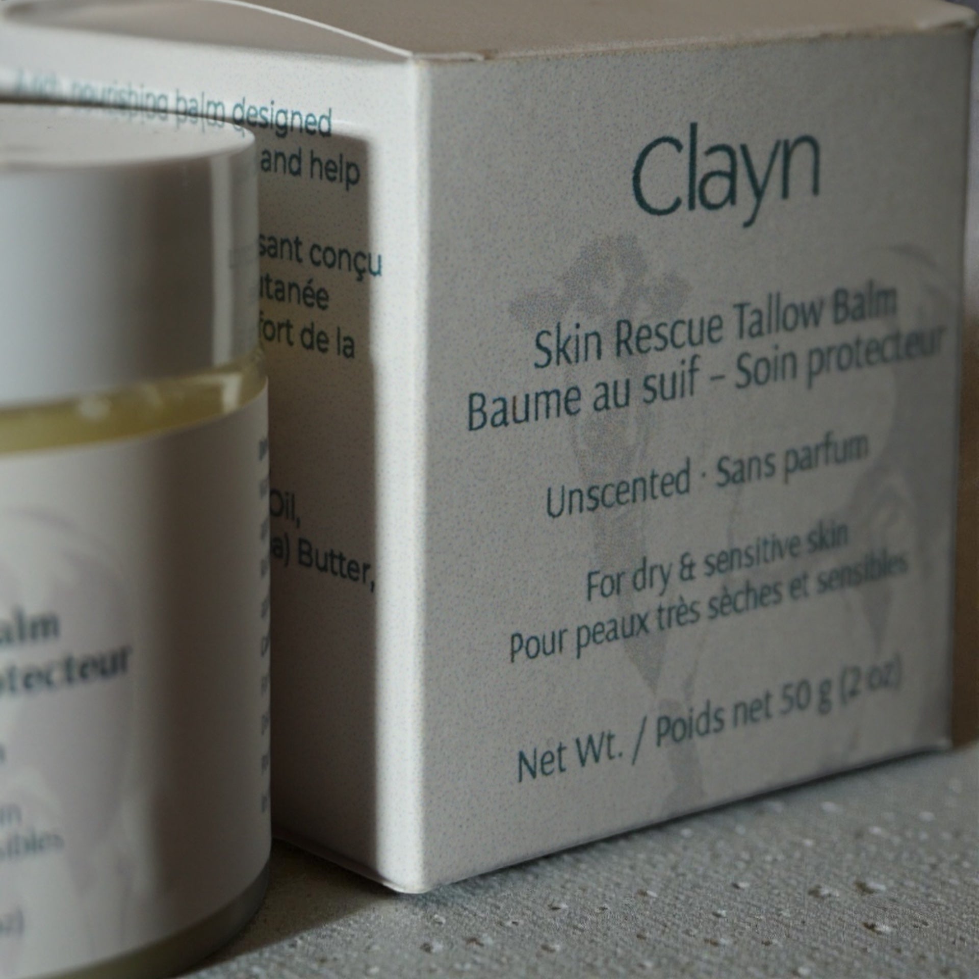 Clayn Skin Rescue Tallow Balm packaging with balm visible on the side.